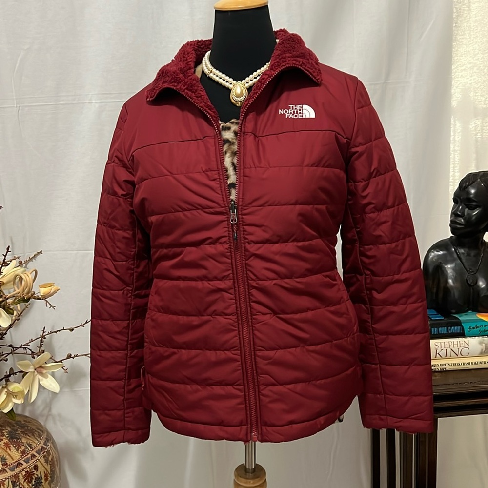 Face the cold weather in a North Face amazing reversible puffer!